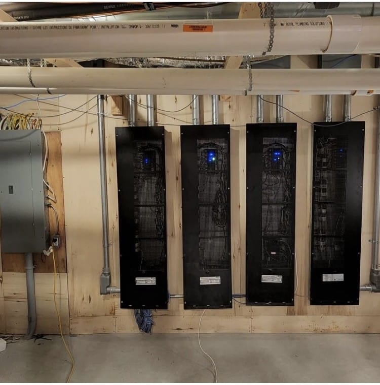 Server racks and electrical panel in industrial setting.