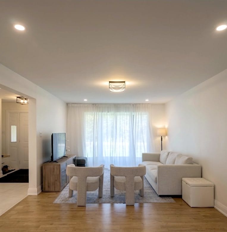 Living room with LED pot lights and a flush-mount fixture, installed by Precise Electrical in Ottawa