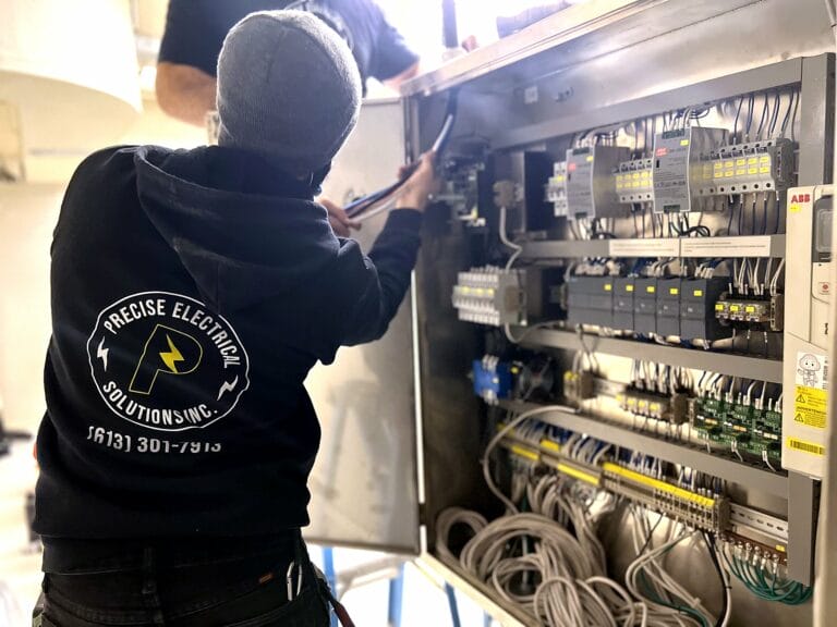Precise Electrical electrician working inside a smart home panel